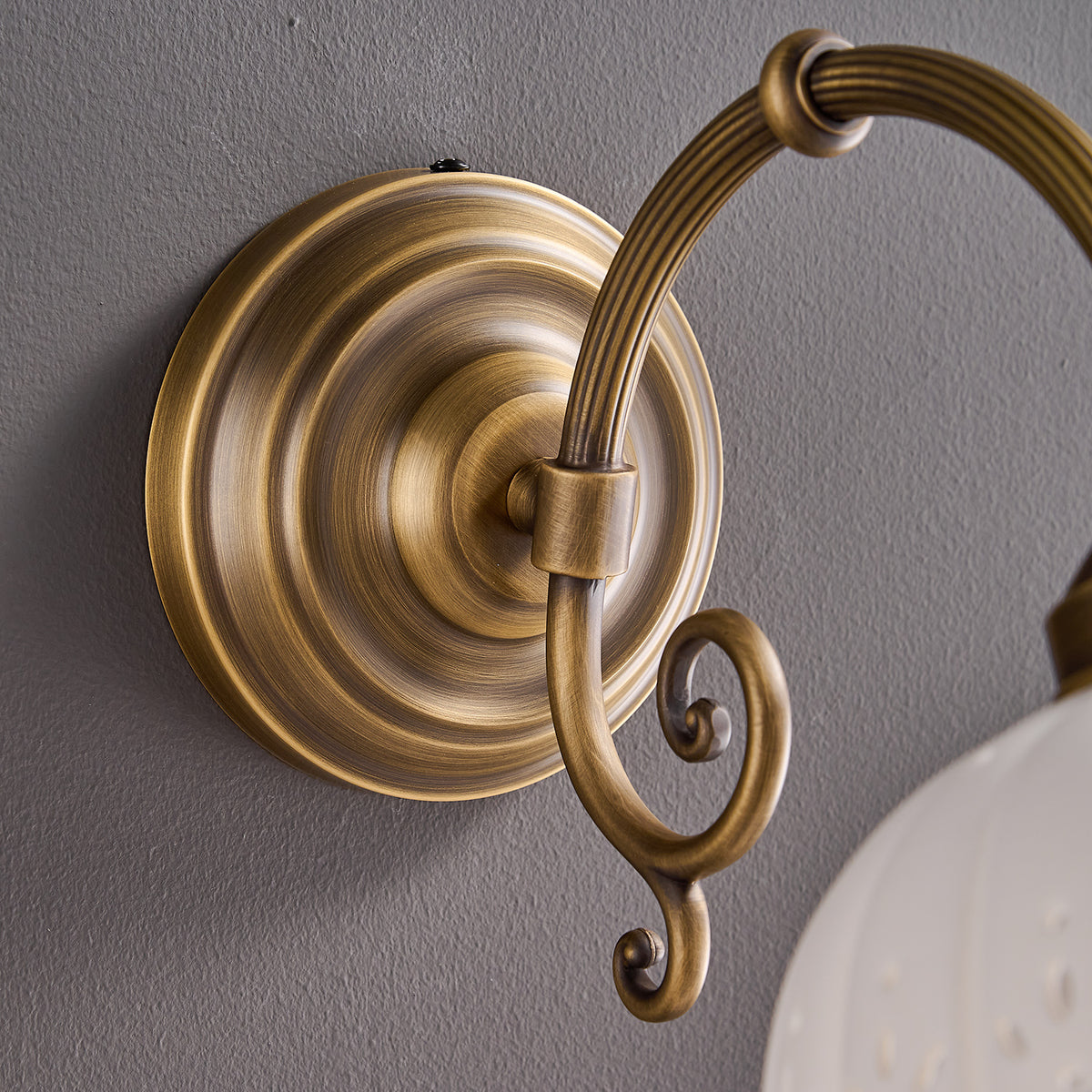 Close-up of antique brass arm and canopy